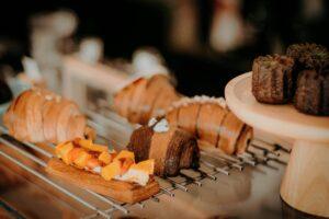 Artisanal pastries and croissants displayed elegantly on a metal tray.