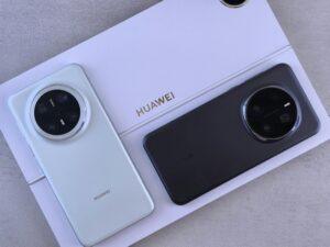 Two smartphones on a Huawei-branded packaging, one white and one black, showcasing modern design.